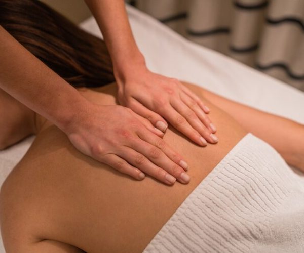 portrait-young-woman-lying-down-table-treatment-receiving-relaxing-back-massage-spa-salon_58466-11969 Belmed Esthetics